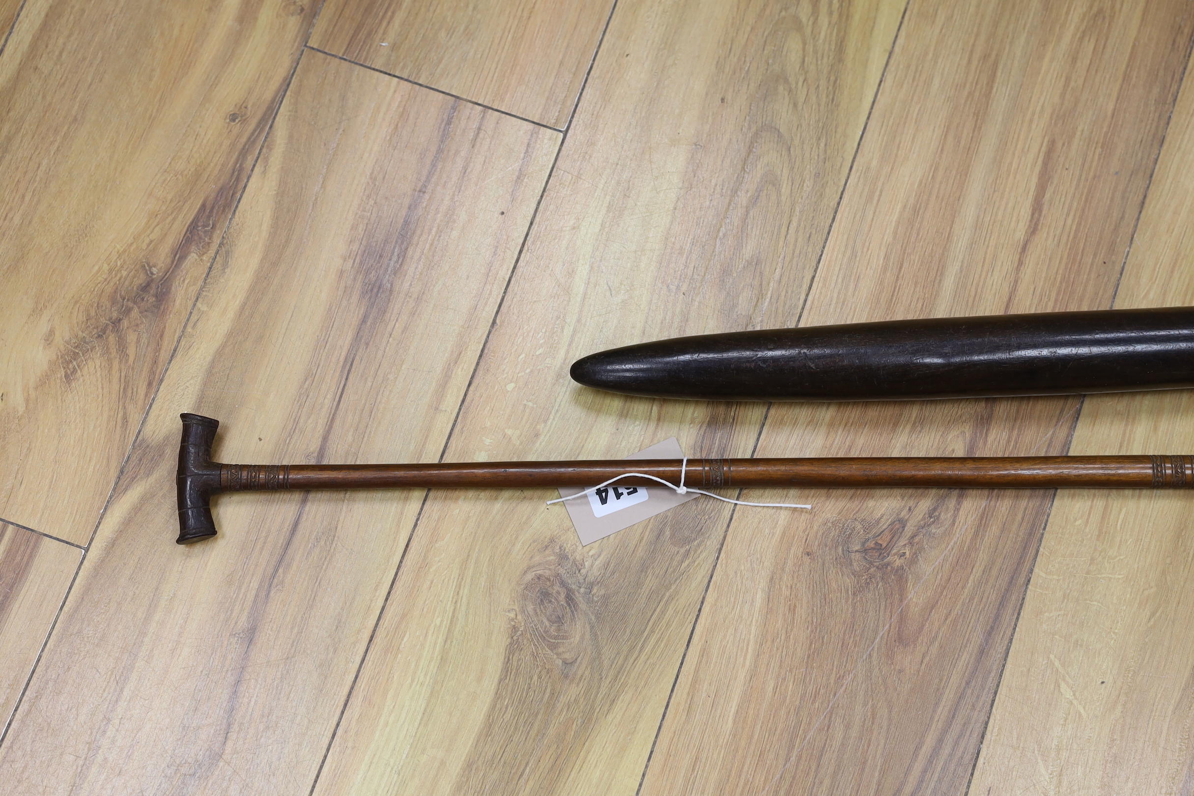 A 19th century Polynesian throwing club, possibly Fiji, and a 19th century ornamental Sri Lankan lady's paddle, 109cm long (2)